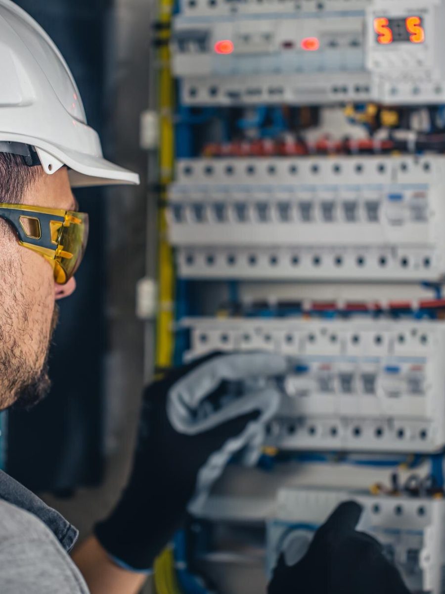 uomo-un-tecnico-elettrico-che-lavora-in-un-quadro-elettrico-con-fusibili_169016-24228